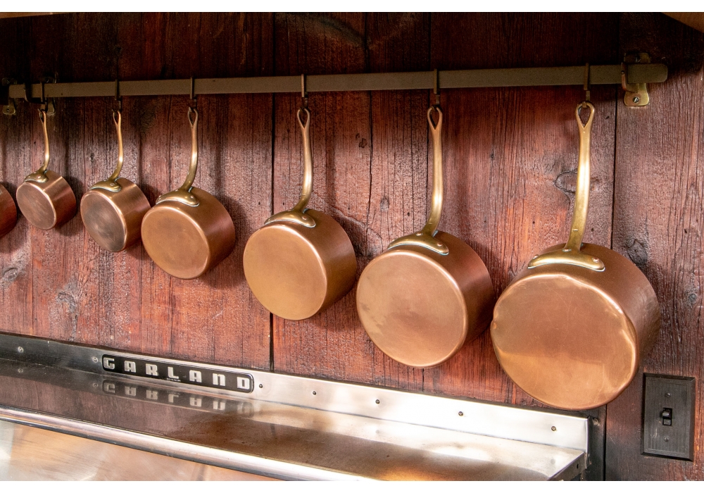 Hand curated copper cookware hailing back to the days of Claude Philippe.