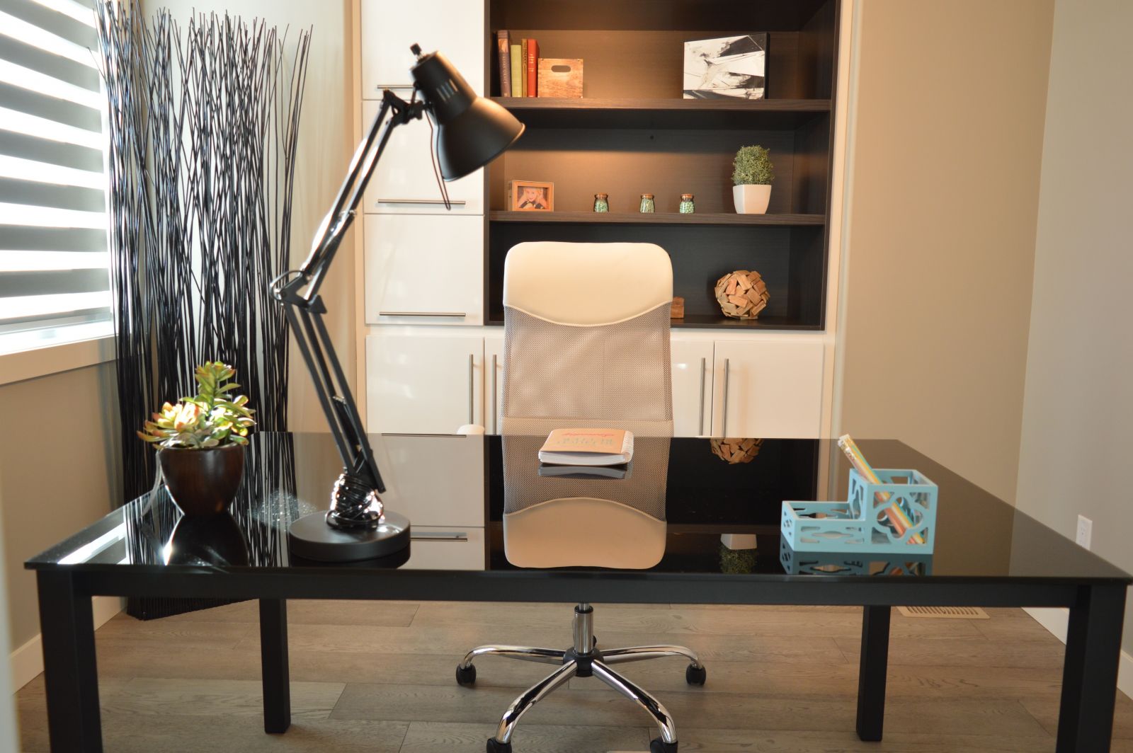Home office with desk, rolling chair, and styled shelves