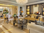 High end living room and dining room with luxury furnishings and large crystal chandelier | BRG