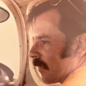 Vintage photo of Harry Laurie inside a vehicle | BRG