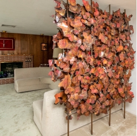 Large Copper Sculpture as room divider by Thomas W. Astle creates a backdrop for their living room's seating area. | BRG