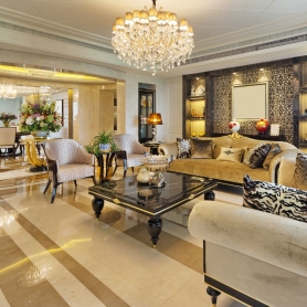 High end living room and dining room with luxury furnishings and large crystal chandelier | BRG