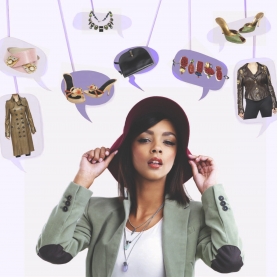 A woman in a designer hat is surrounded by an assortment of luxury goods and designer fashions | BRG