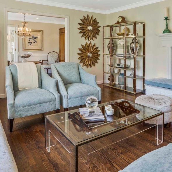 a well decorated living room with light blue upholstered chairs | BRG