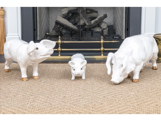 A Family Of Three French White Glazed Terracotta Pigs