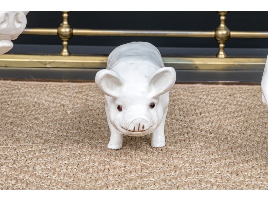 A Family Of Three French White Glazed Terracotta Pigs