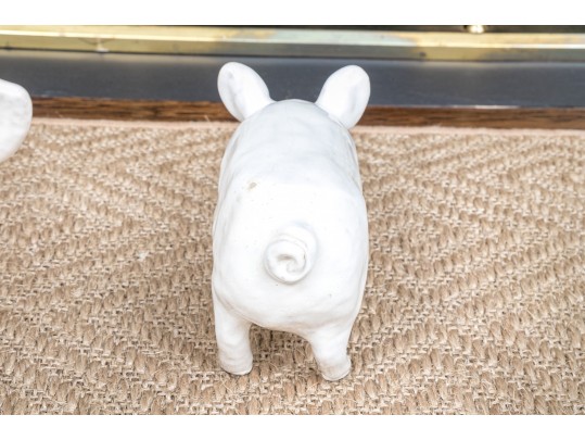 A Family Of Three French White Glazed Terracotta Pigs