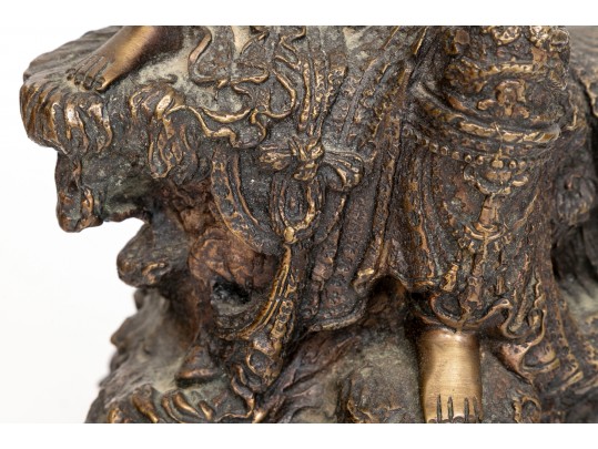 A 20th Century Asian Bronze Figure Of A Reclining Female Deity On A Rock