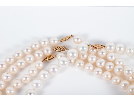 Four Similar Knotted Large Cultured Pearl Necklaces With 14k Yellow Gold Claps