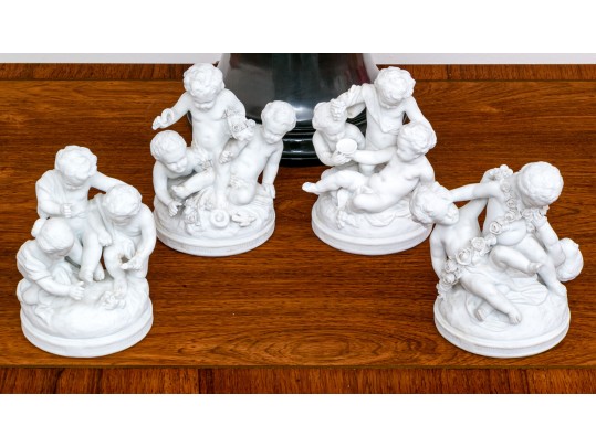 Collection Of Four Continental Bisque Porcelain Cherub Figural Sculptures