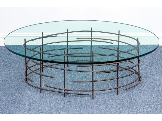 A Beautiful Oval Iron And Thick Glass Cocktail Table