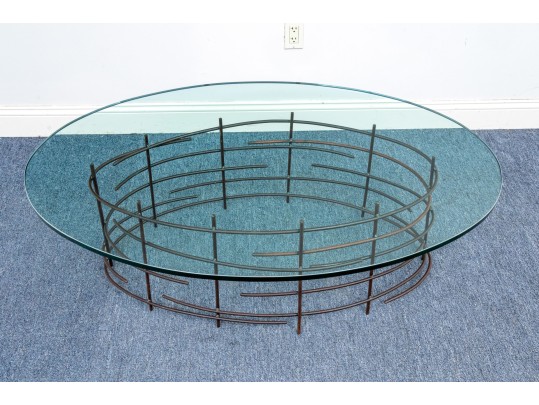 A Beautiful Oval Iron And Thick Glass Cocktail Table