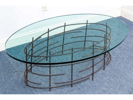 A Beautiful Oval Iron And Thick Glass Cocktail Table