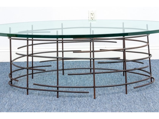 A Beautiful Oval Iron And Thick Glass Cocktail Table