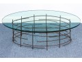 A Beautiful Oval Iron And Thick Glass Cocktail Table