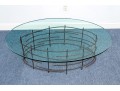 A Beautiful Oval Iron And Thick Glass Cocktail Table