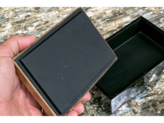 Two Decorative Table Top Items, Including A Striped Lidded Box, And Matchstrike 