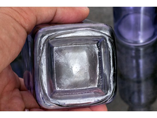 Decorative Collection Of Four Purple Hued Glass Vases