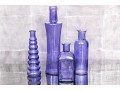 Decorative Collection Of Four Purple Hued Glass Vases
