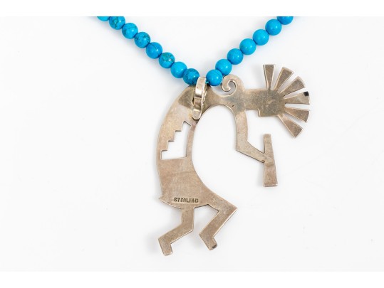 Sterling Silver Impactful Large Kokopeli Pendant, Displayed On A Blue Glass Bead Necklace