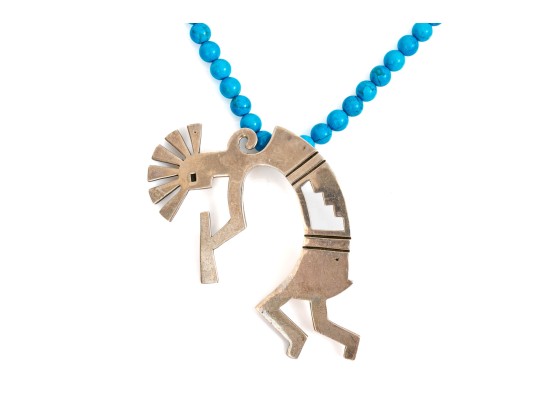Sterling Silver Impactful Large Kokopeli Pendant, Displayed On A Blue Glass Bead Necklace