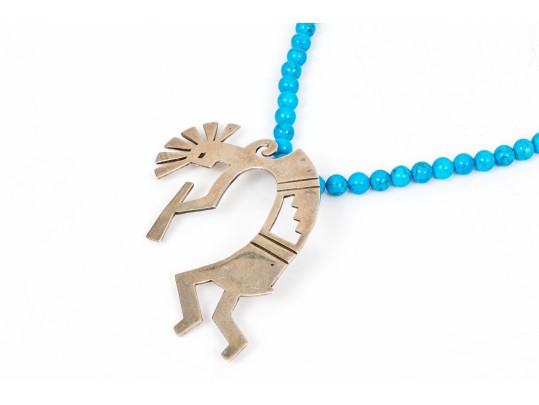 Sterling Silver Impactful Large Kokopeli Pendant, Displayed On A Blue Glass Bead Necklace