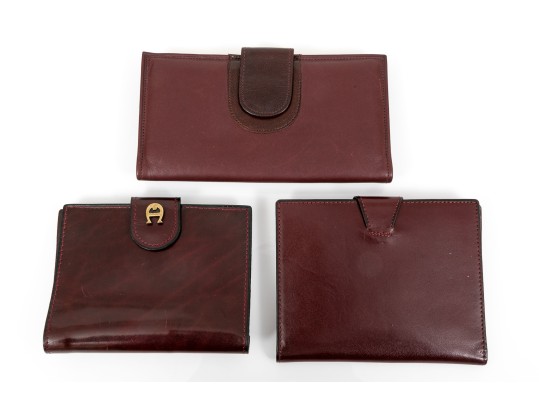 Collection Of Three Burgundy Wallets, Including Etienne Aigner