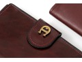 Collection Of Three Burgundy Wallets, Including Etienne Aigner