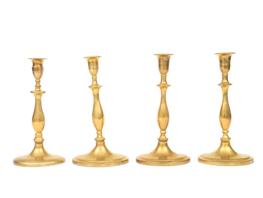 Compatible Set Of Four Antique Brass Candlesticks