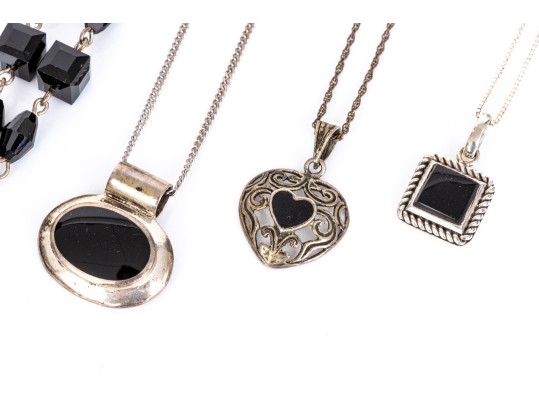 Collection Of Sterling Silver And Onyx Motif Jewelry Pieces