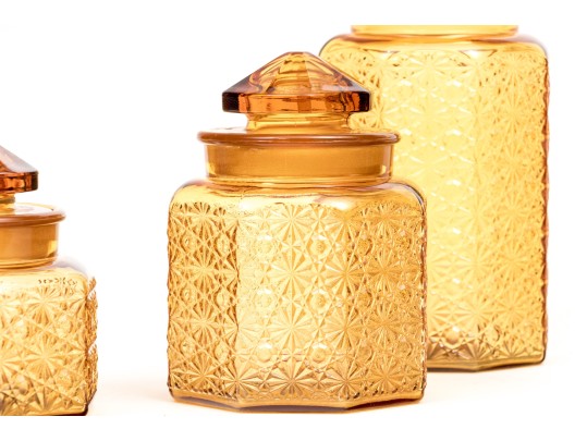 Collection Of Four Amber Glass Vessels With Three Lids