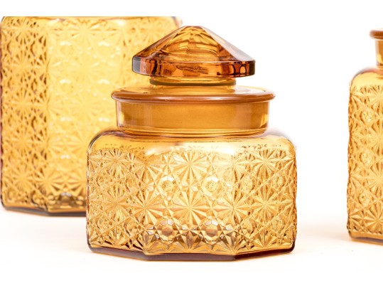 Collection Of Four Amber Glass Vessels With Three Lids