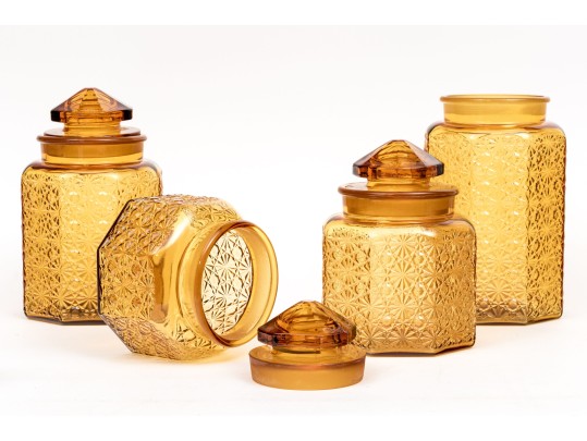 Collection Of Four Amber Glass Vessels With Three Lids