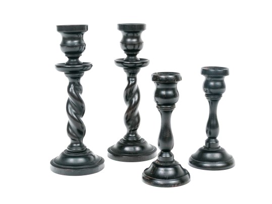 Grouping Of Four Carved Ebony Candlesticks, Including Two Pairs