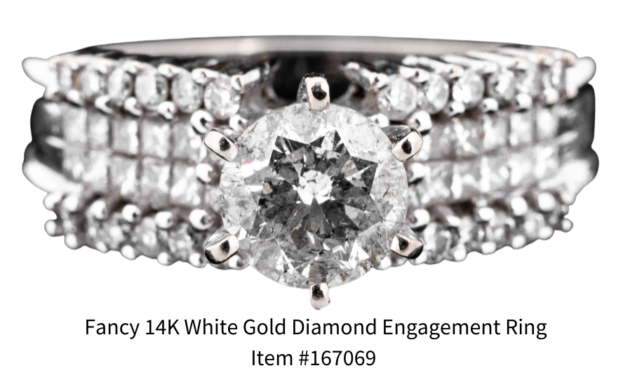 A stunning 14K white gold diamond engagement ring, size 7 features round faceted diamond with two rows of channel set square cut diamonds.