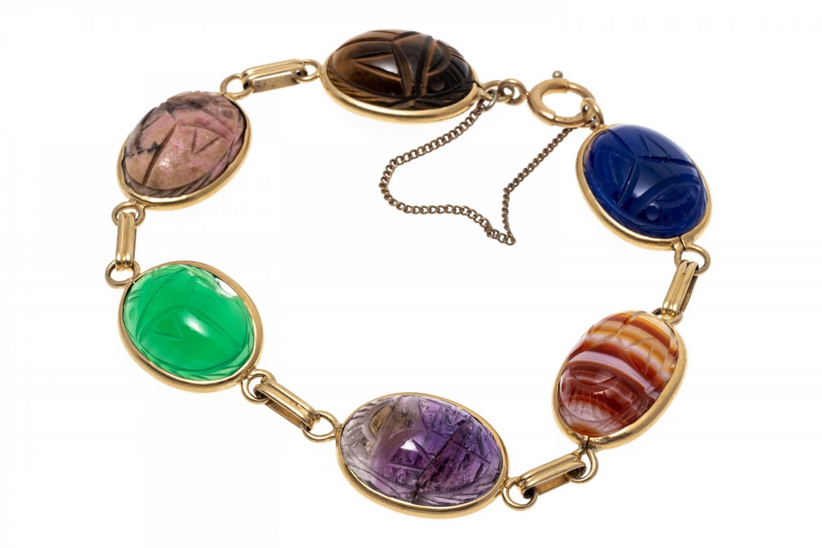 14k yellow gold bracelet. This attractive bracelet is a scarab link style, set with carved tigers eye, rhodonite, green chalcedony, amethyst, agate and blue onyx stones, bezel set