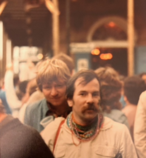 A vintage candid image of Harry Laurie walking down a crowded street