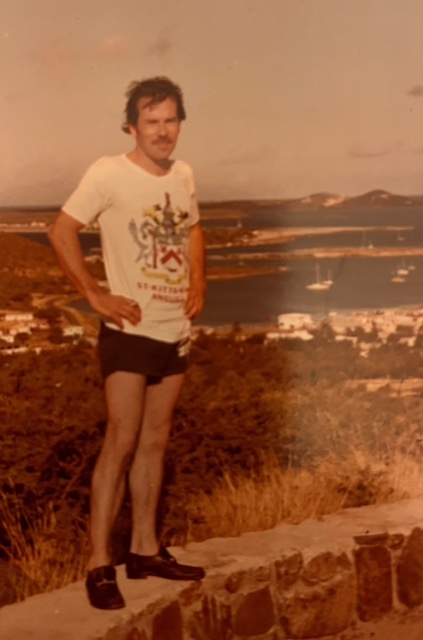 Vintage photo of Harry Laurie who appears in a white graphic tee-shirt and shorts