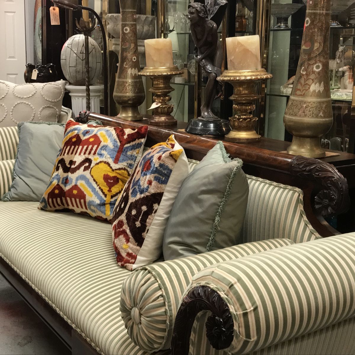 Interesting pillow patterns update the look of this antique settee