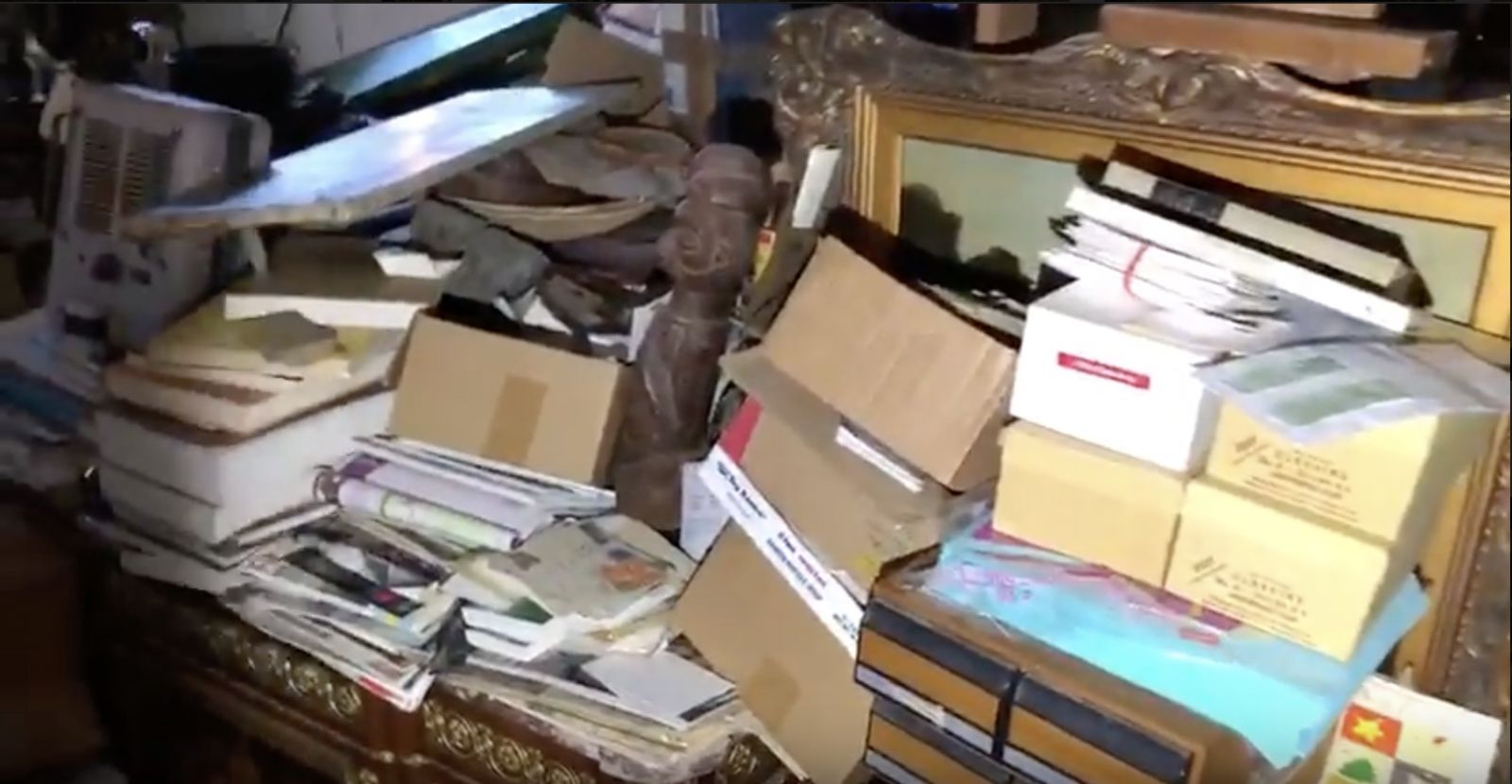 Boxes of letters, stamp collection, and coins surround countless works of art in this high-end hoarder estate.