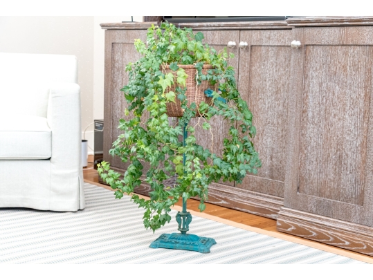 Decorative Antiqued Plant Stand With Ivy Plant In Woven Planter