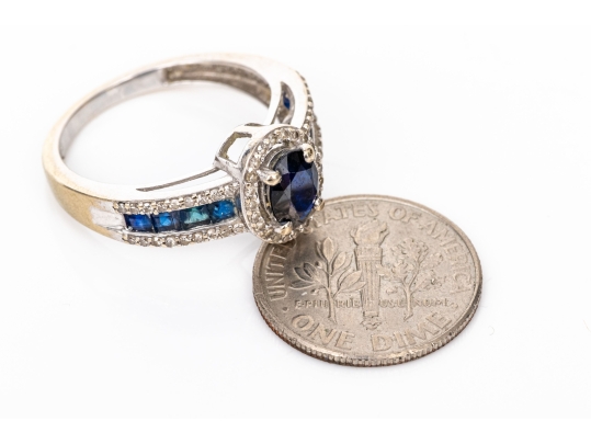 14k White Gold Oval And Calibre Sapphire And Diamond Halo Ring, App. 0.15 TCW, Size 7