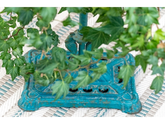 Decorative Antiqued Plant Stand With Ivy Plant In Woven Planter