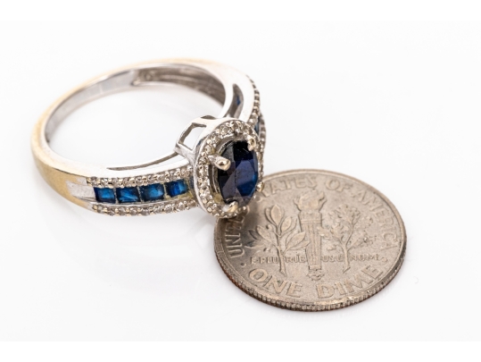 14k White Gold Oval And Calibre Sapphire And Diamond Halo Ring, App. 0.15 TCW, Size 7