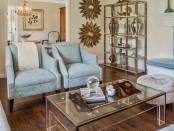 a well decorated living room with light blue upholstered chairs | BRG